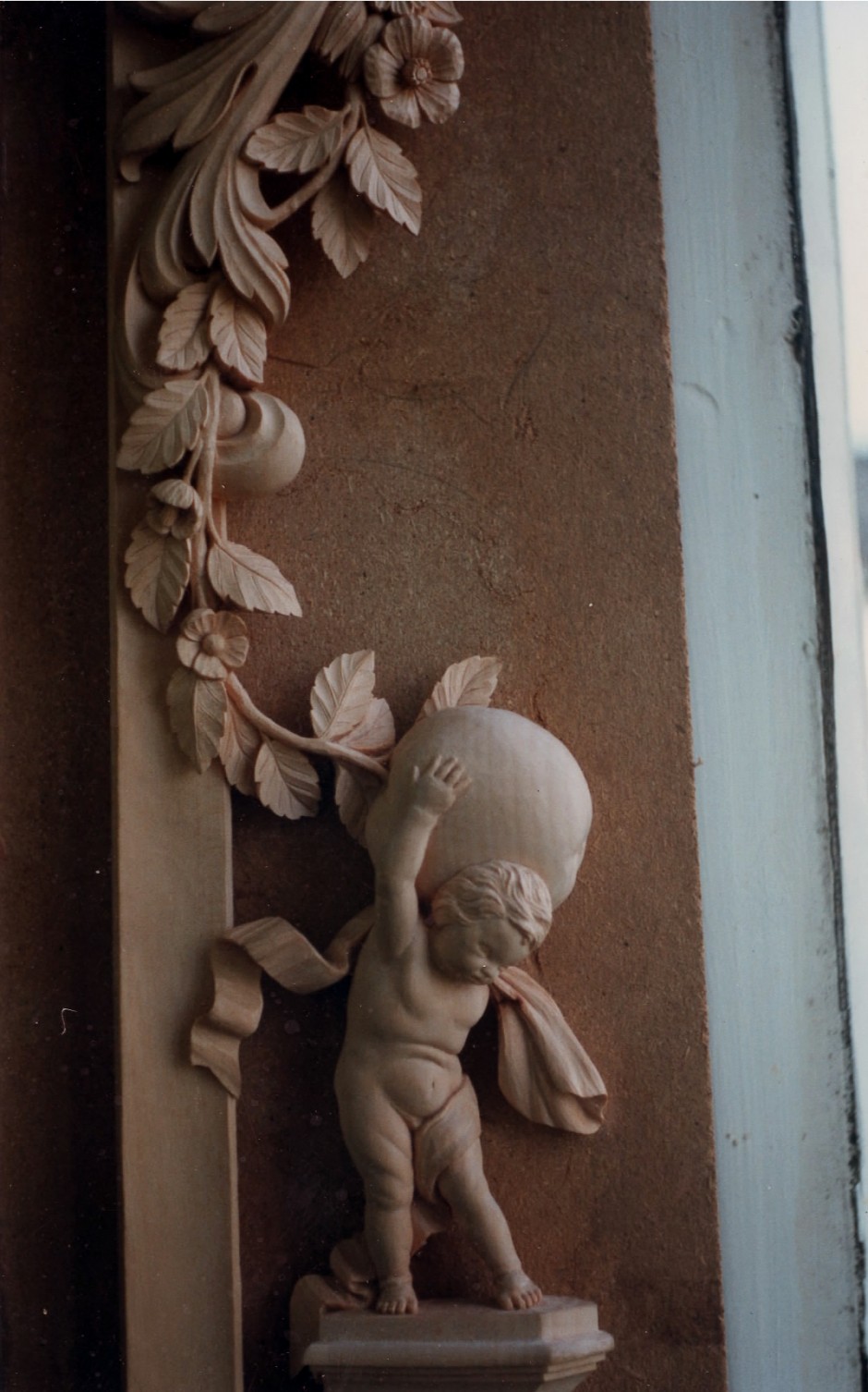 Close up detail of the right hand frame showing cherub - cherub carving