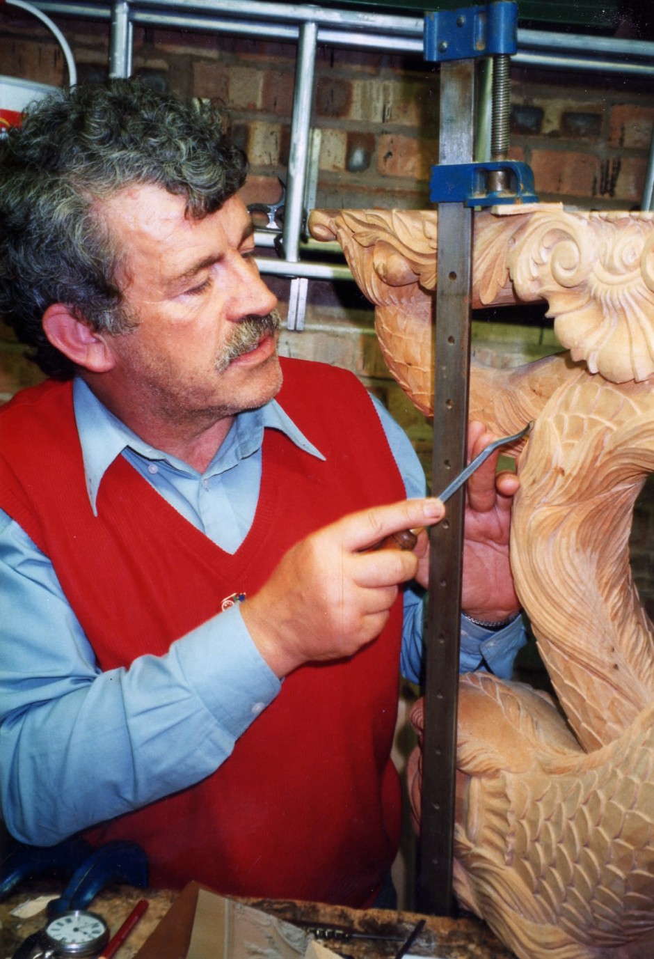 Jose adds final details to the carvings - final carving, light touches