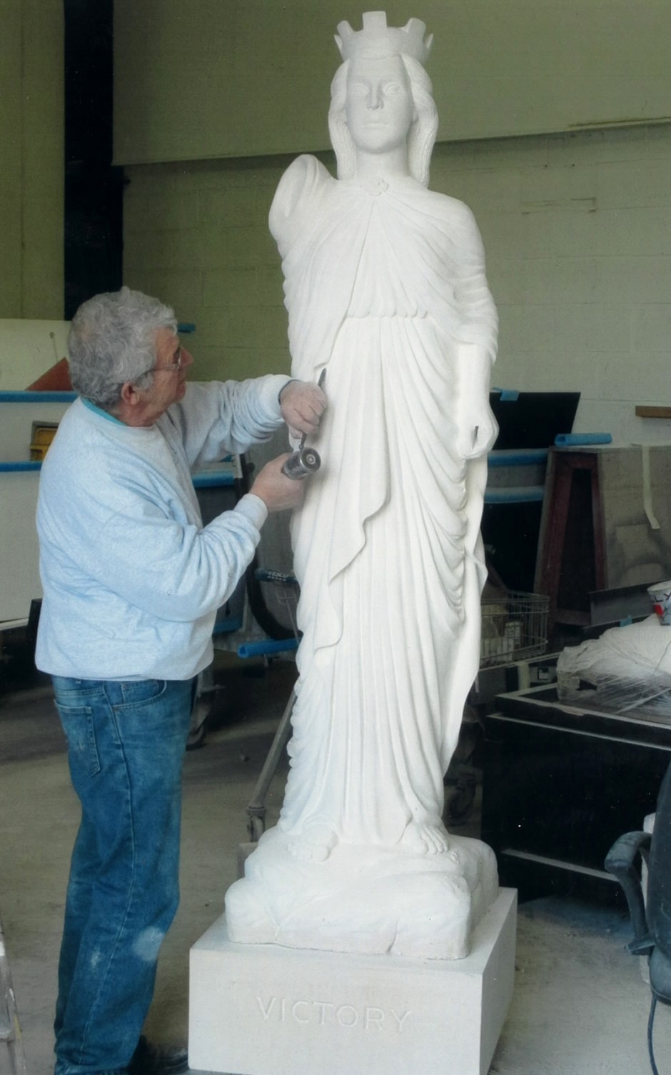 Jose carrying out final detail carving - nike horndean statue carving