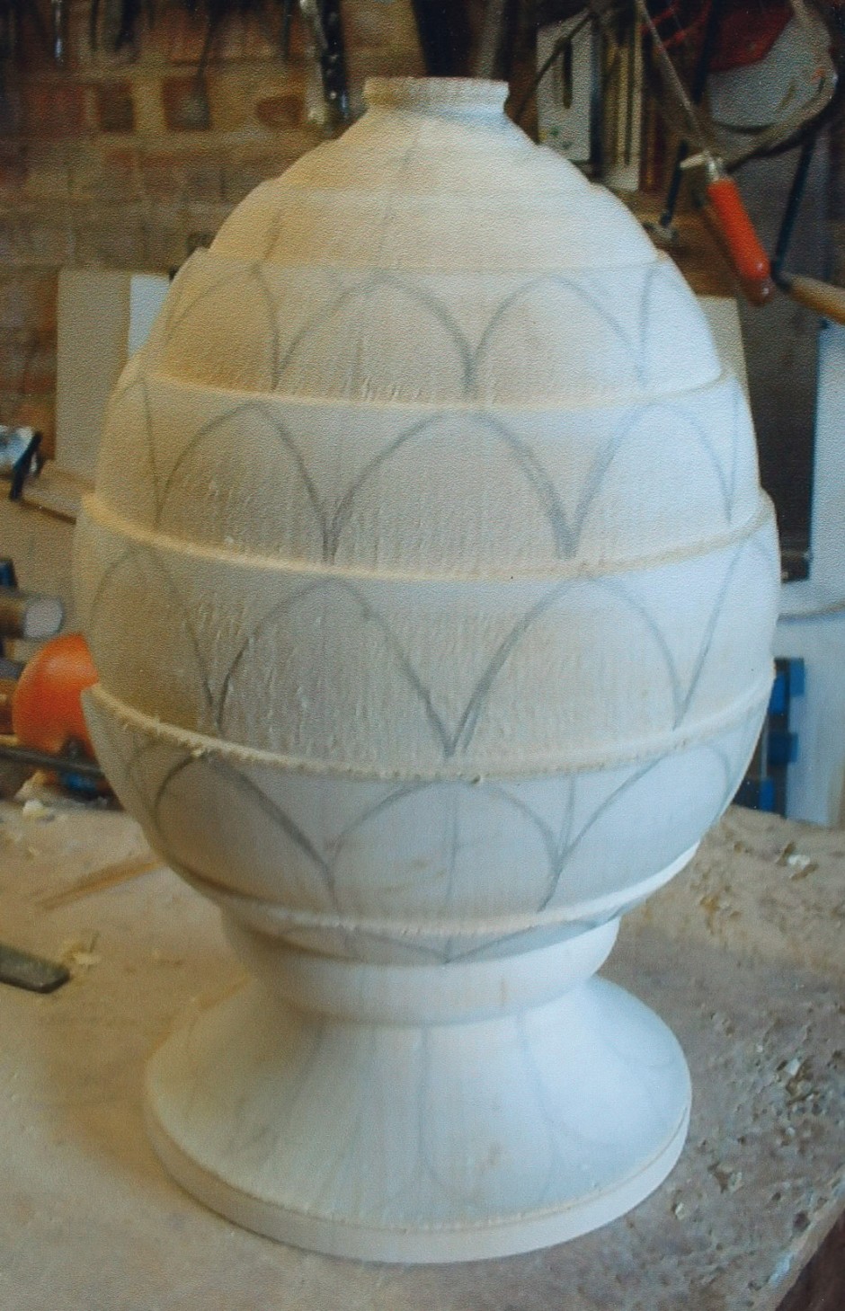 The basic design is sketched on the shaped wood - pineapple design, wood shape, sketching, ornament, casting for stone